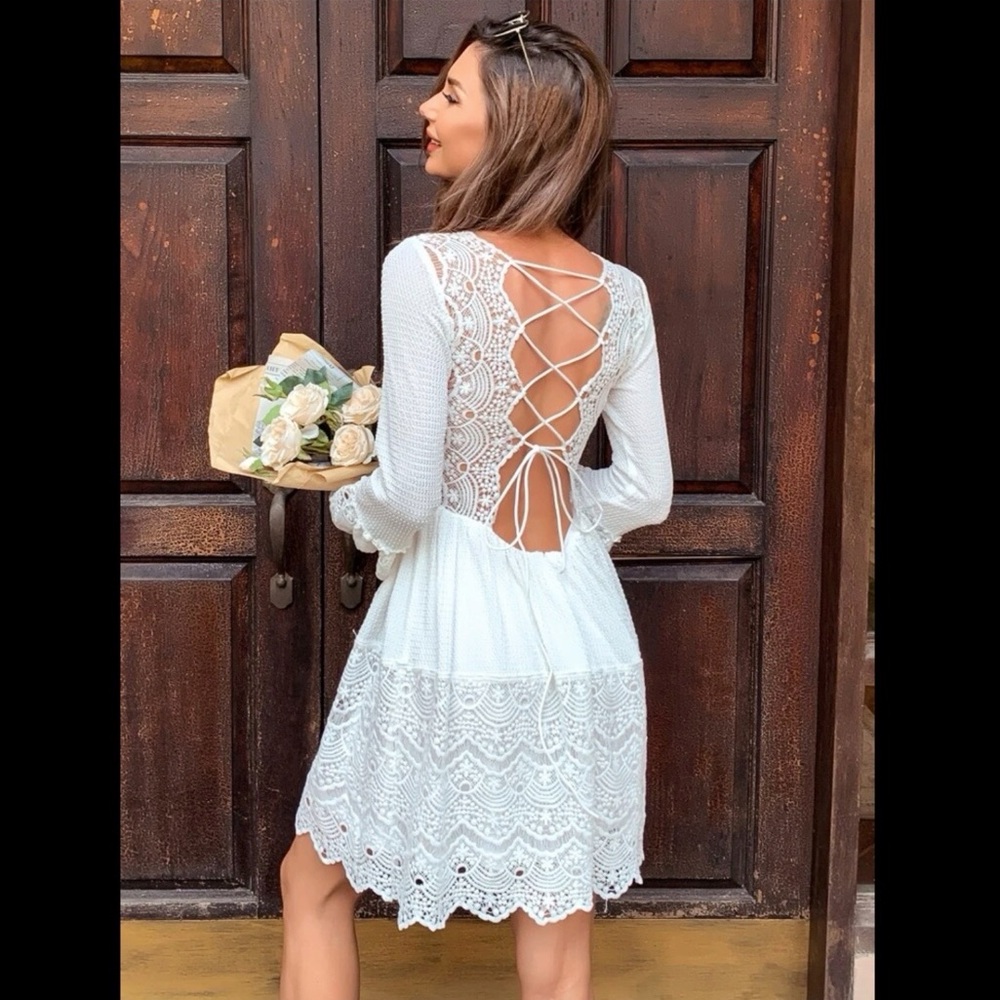White, lace back dress with bell sleeves. Backless.